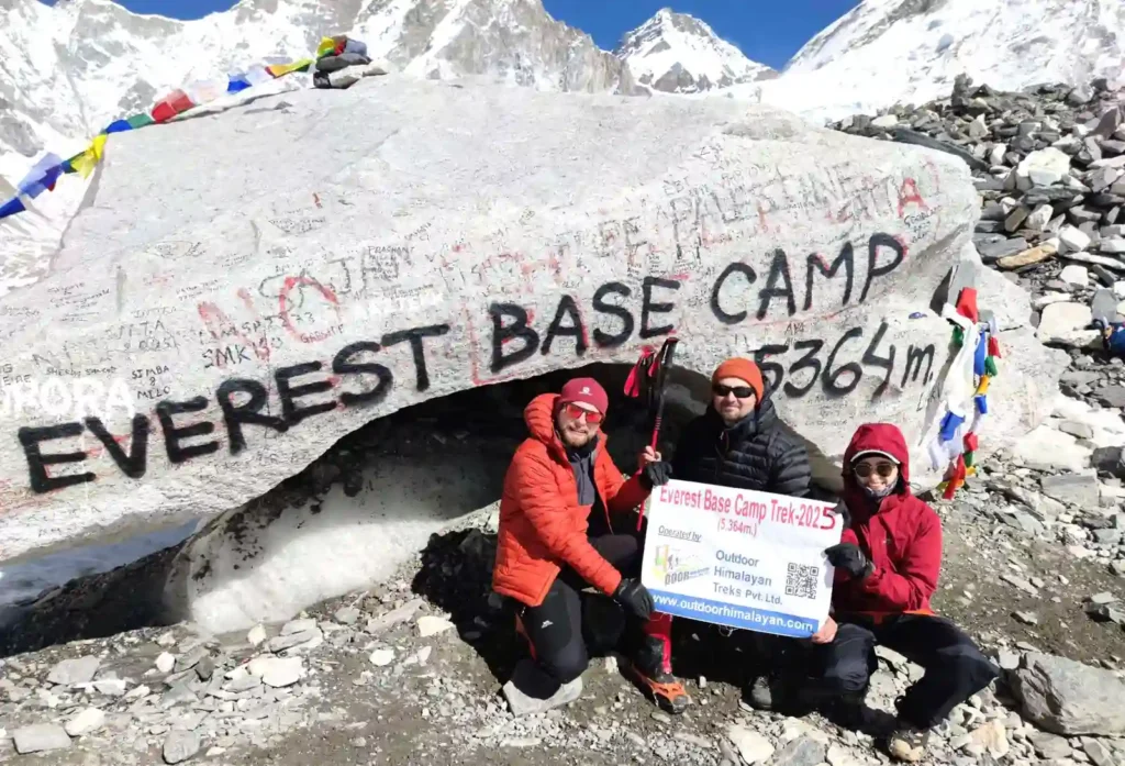How much does trekking cost in nepal? (a realistic 2026 budget). 3 The iconic Everest Base Camp rock covered in yellow prayer flags with Khumbu Icefall in the background